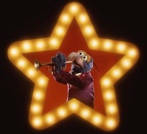 Gonzo the Great blowing a trumpet inside a star frame